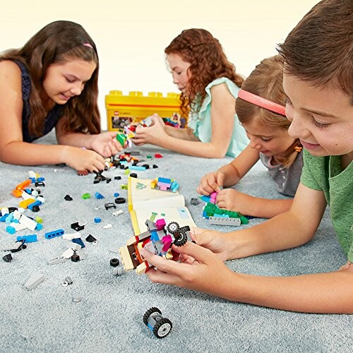 Children playing with LEGO bricks on a carpet